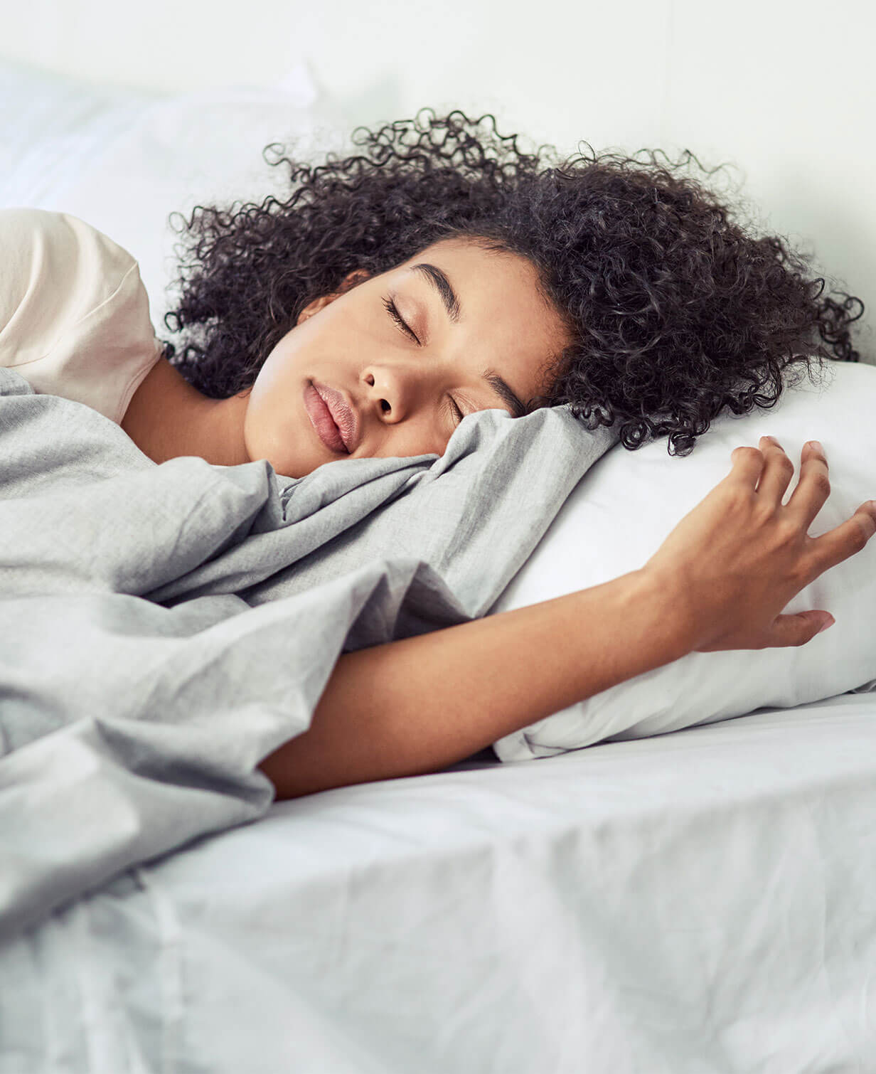 woman sleeping on cotton bedding