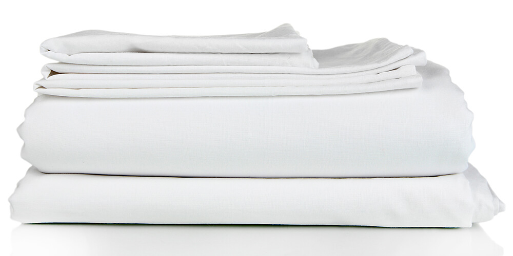 a stack of white bedsheets
