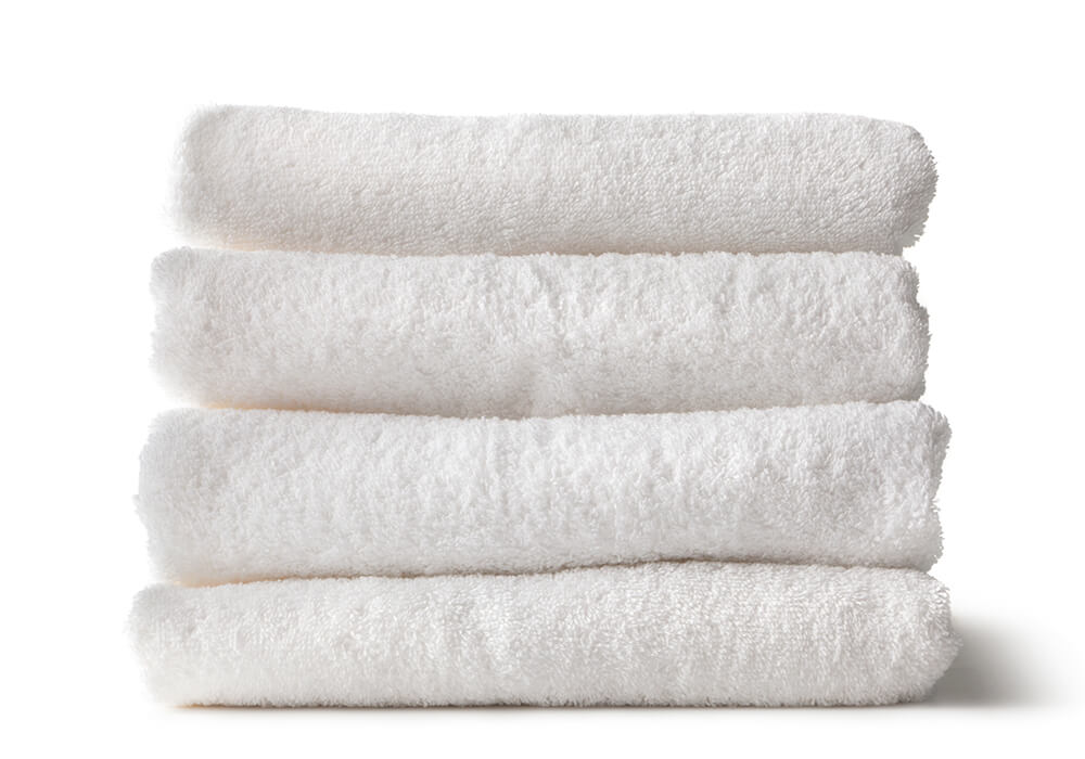 4 white stacked towels