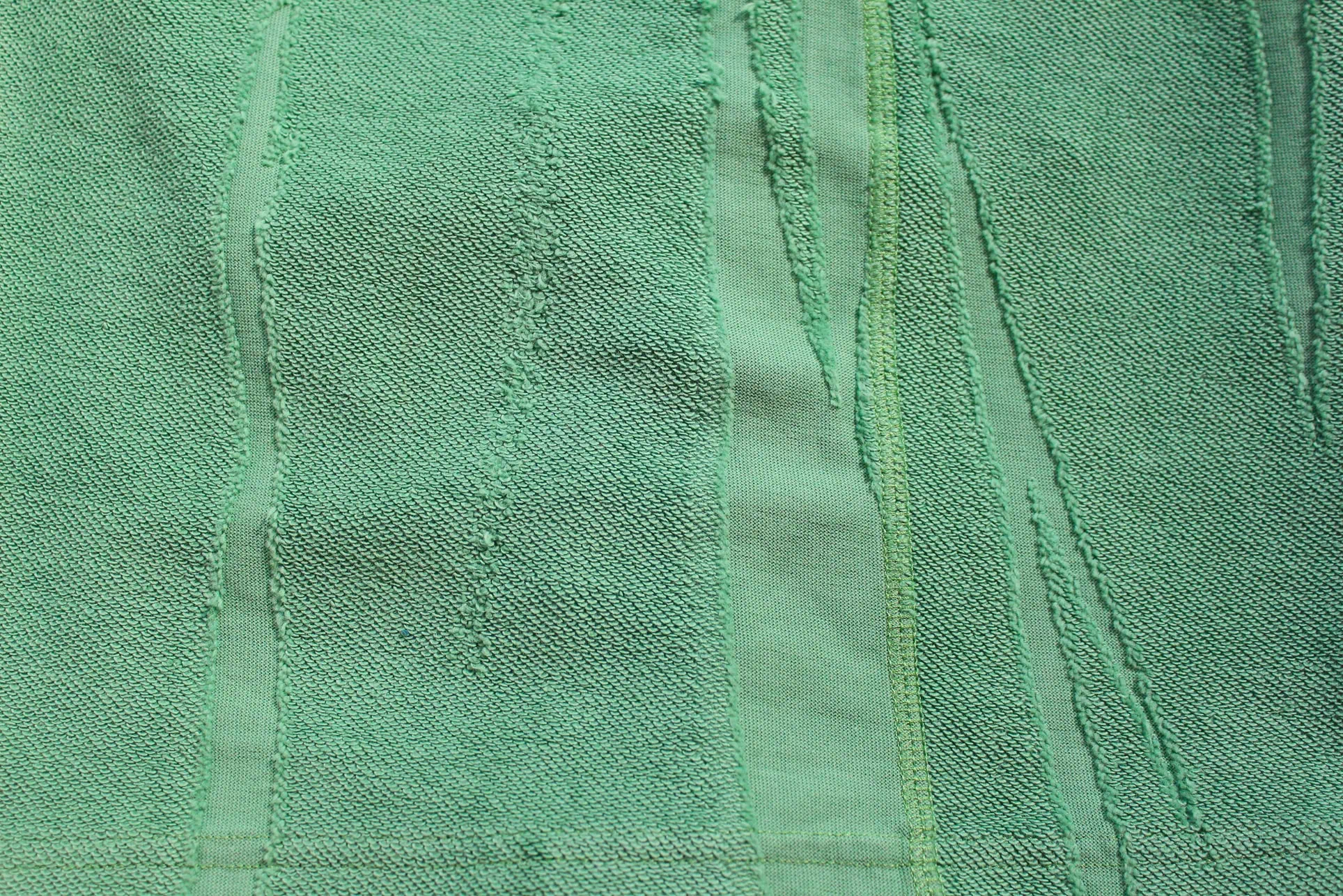 Close-up of knit jacquard Terry fabric for shorts, featuring a streaky pattern that creates a reverse texture.
