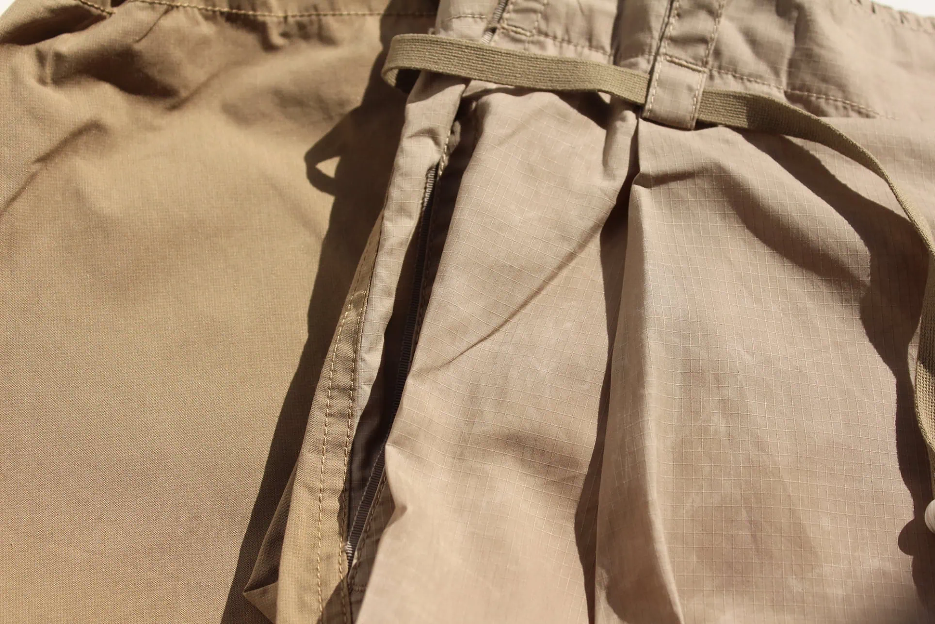 Close-up of lightweight cotton ripstop fabric with a natural wax finish, enhancing its wind and water resistance