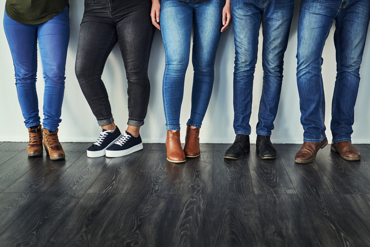 Group of people wearing different styles and washes of denim jeans
